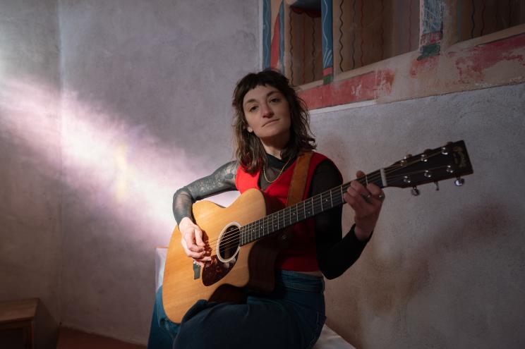 person with an acoustic guitar