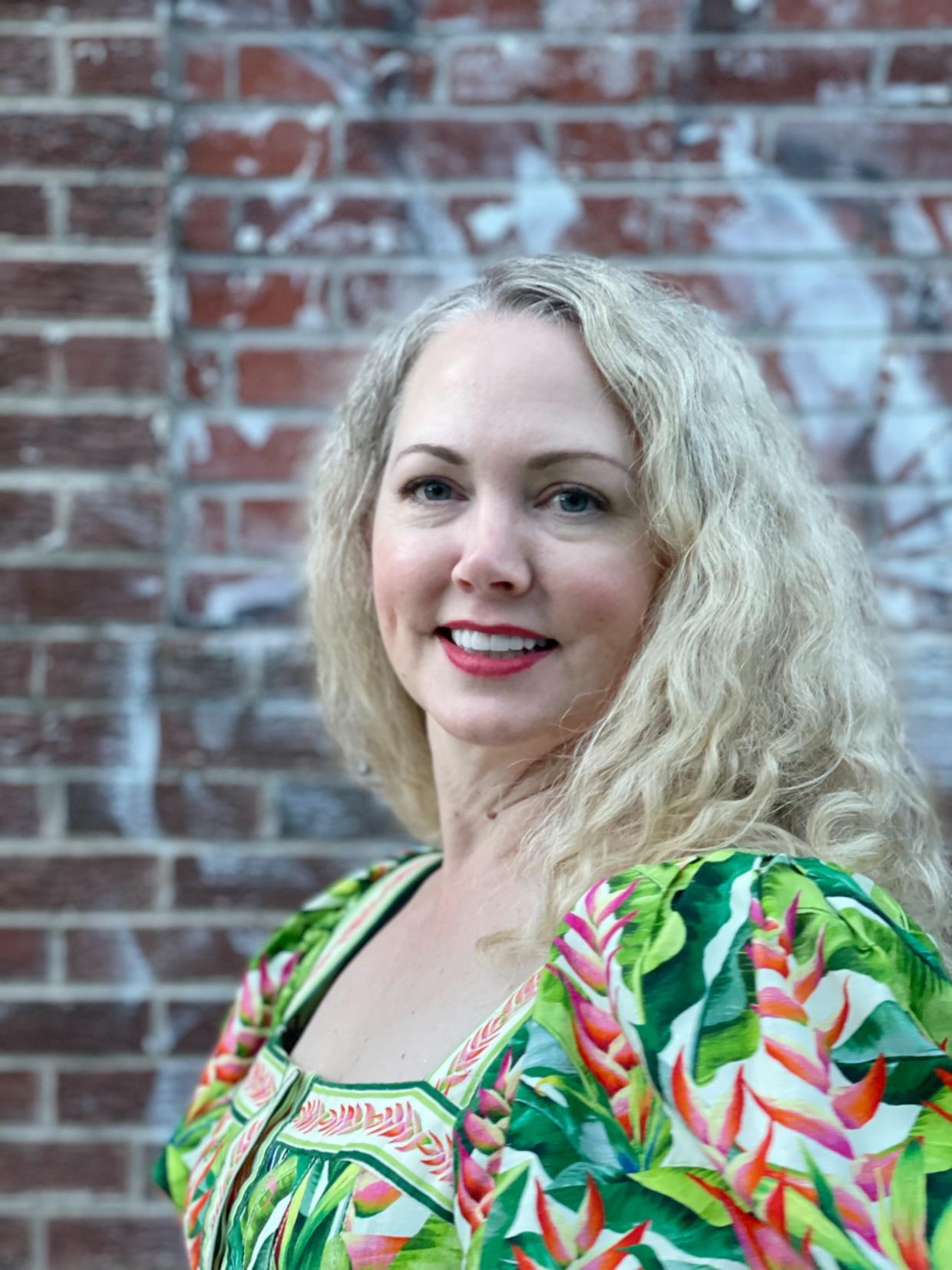 A blonde woman in a green shirt
