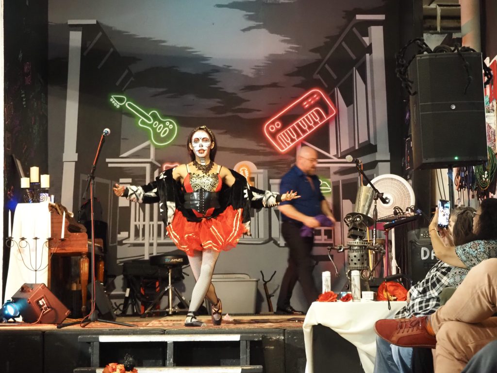 A dancer in a red tutu and face paint