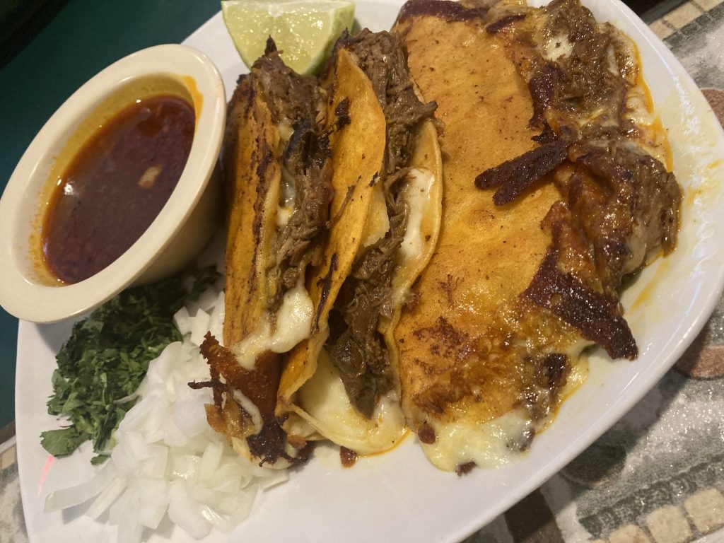 a plate of birria tacos