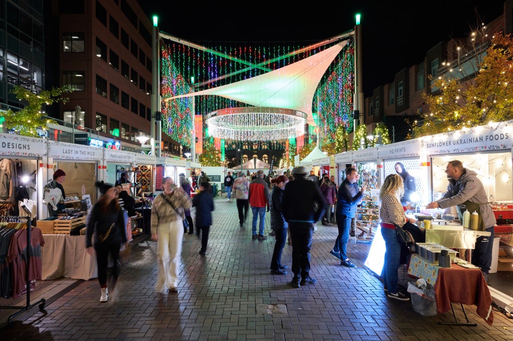 Local booths and decorative lights displayed during the Cherry Creek Holiday Market