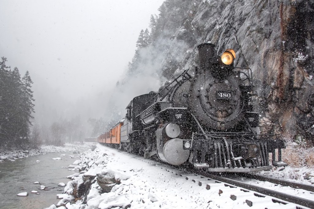 The Durango & Silverton Narrow Gauge Railroad train chugging through the snowy San Juans