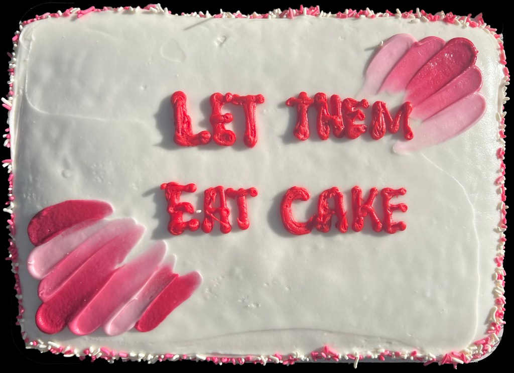 A cake reading "Let them eat cake"