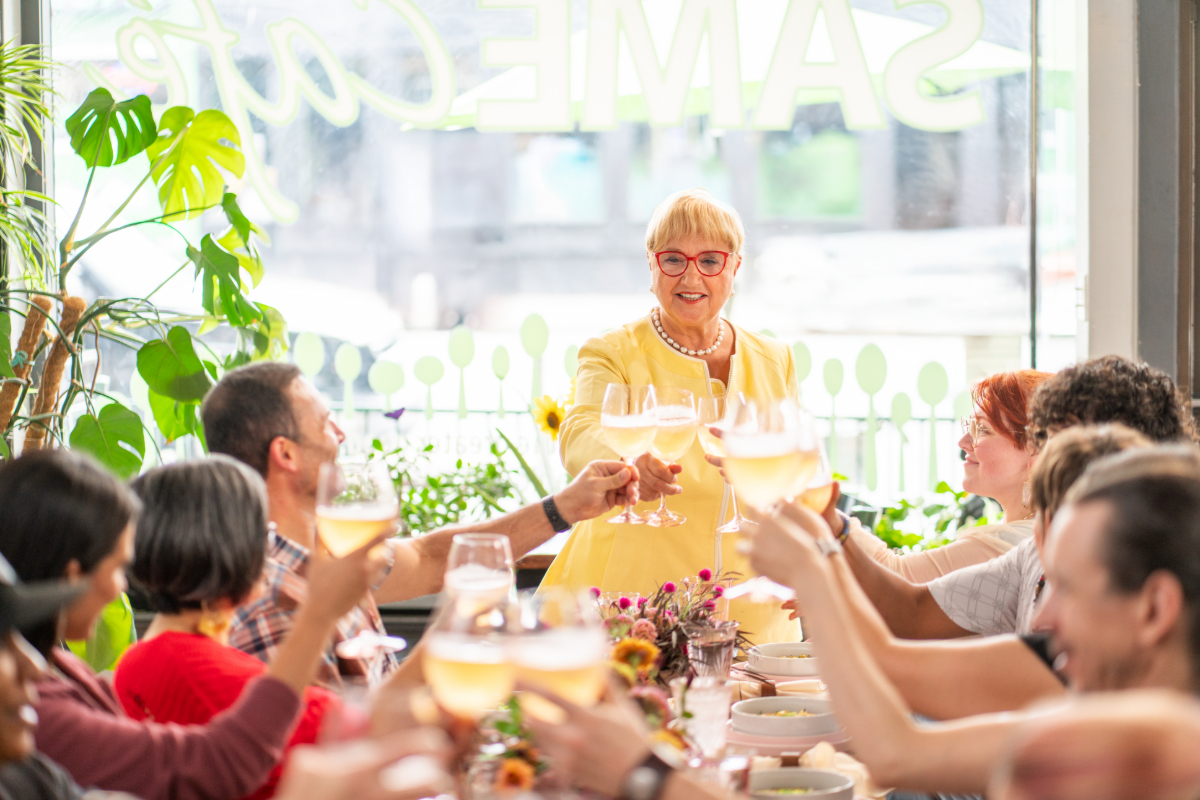 woman standing at the head of a table