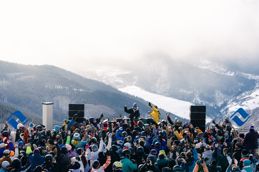 Crowds surrounding a live DJ at a mountaintop venue at Vail Mountain