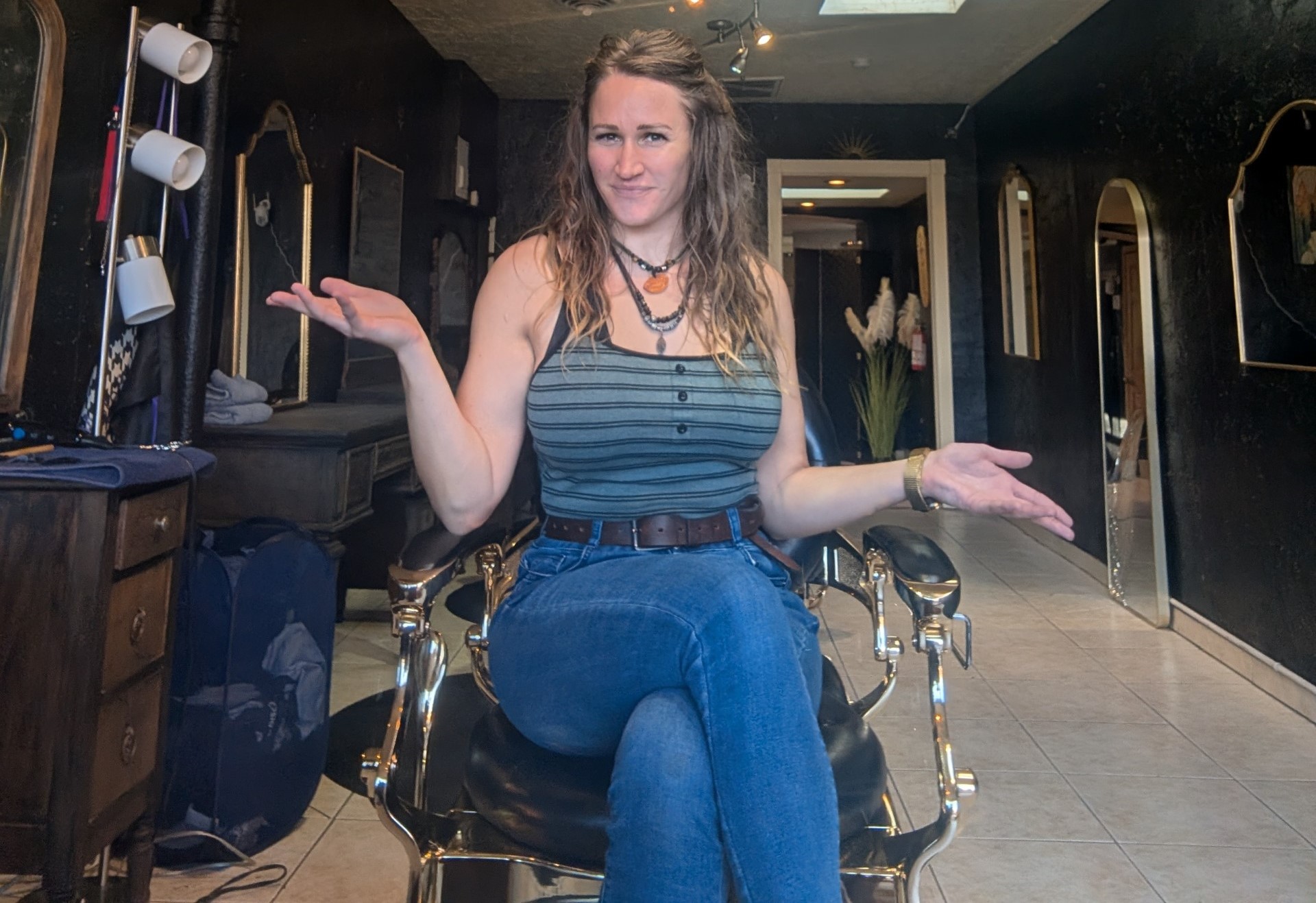 A portrait of a woman in a hair salon chair