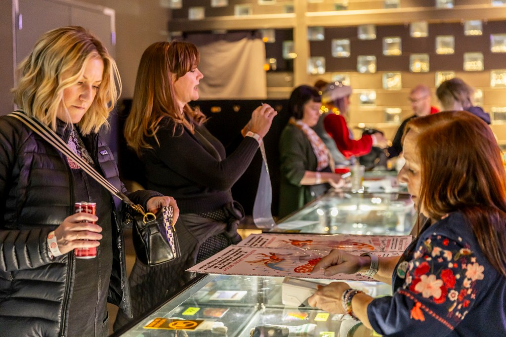 Fans shopping at the merch booth.