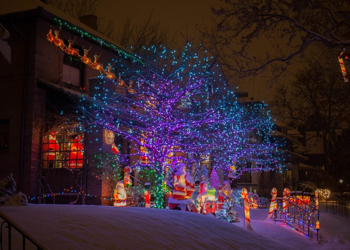 Denver house lit up with Christmas lights and decorations in snow