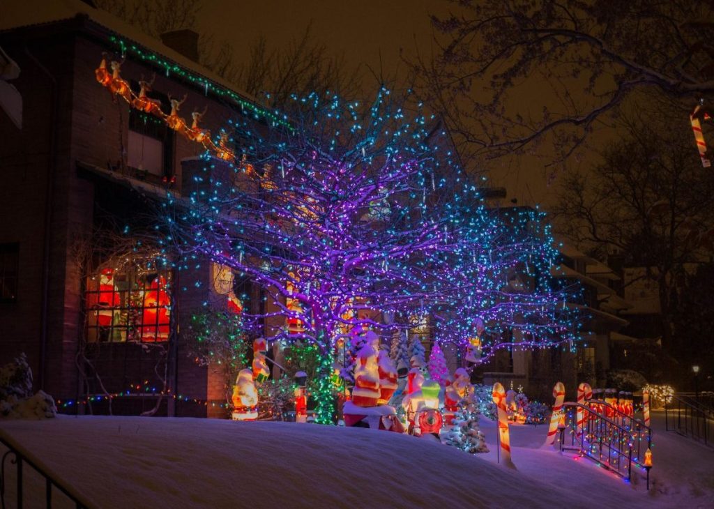 Denver house lit up with Christmas lights and decorations in snow