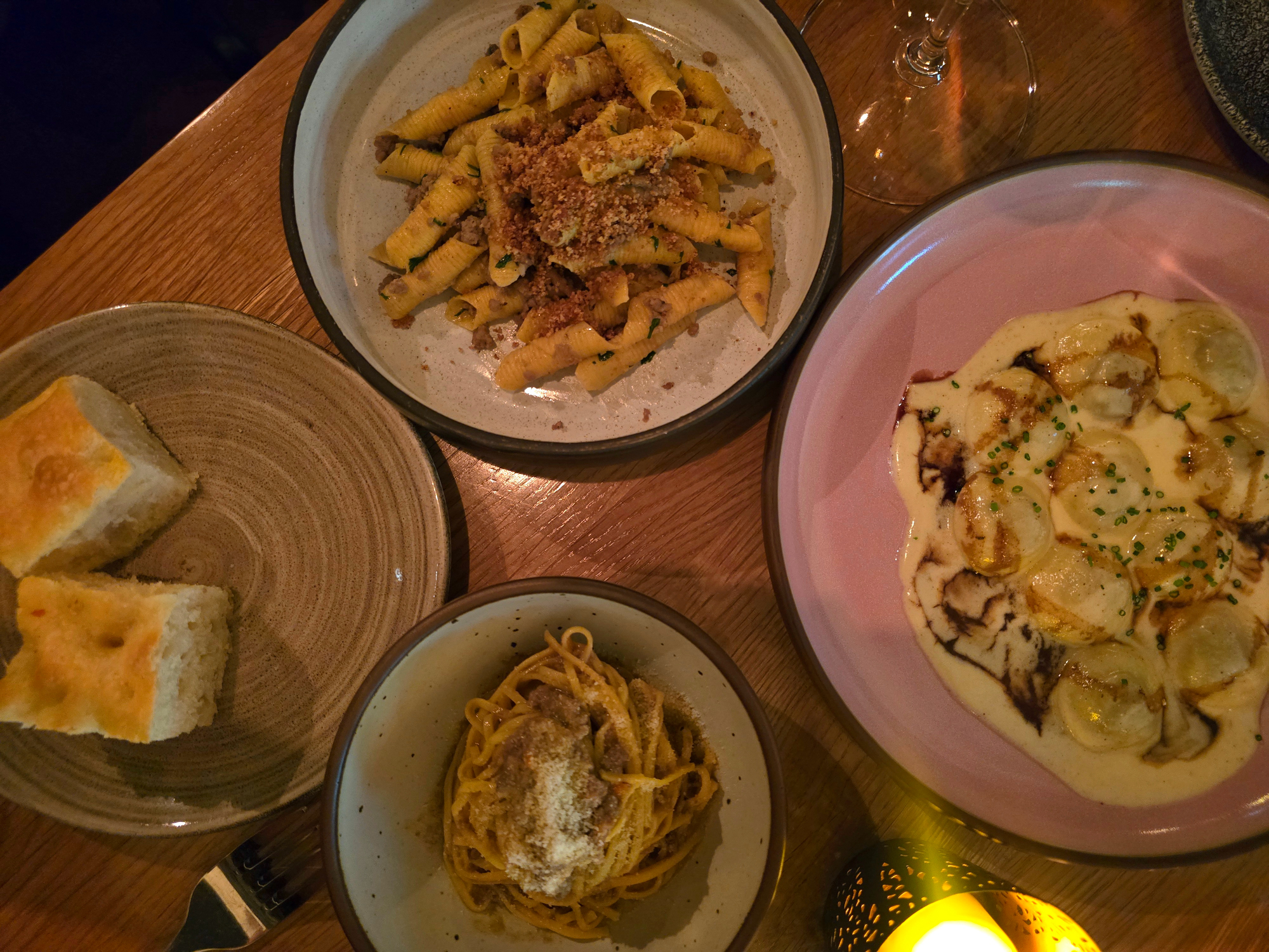 three pasta dishes on a table
