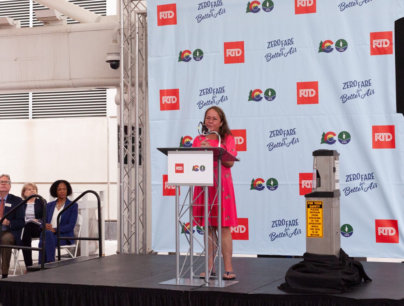 woman speaks on stage during press conference