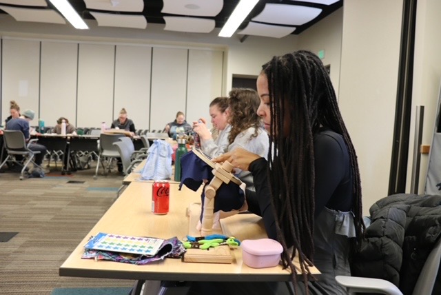 People work on crafts at a table