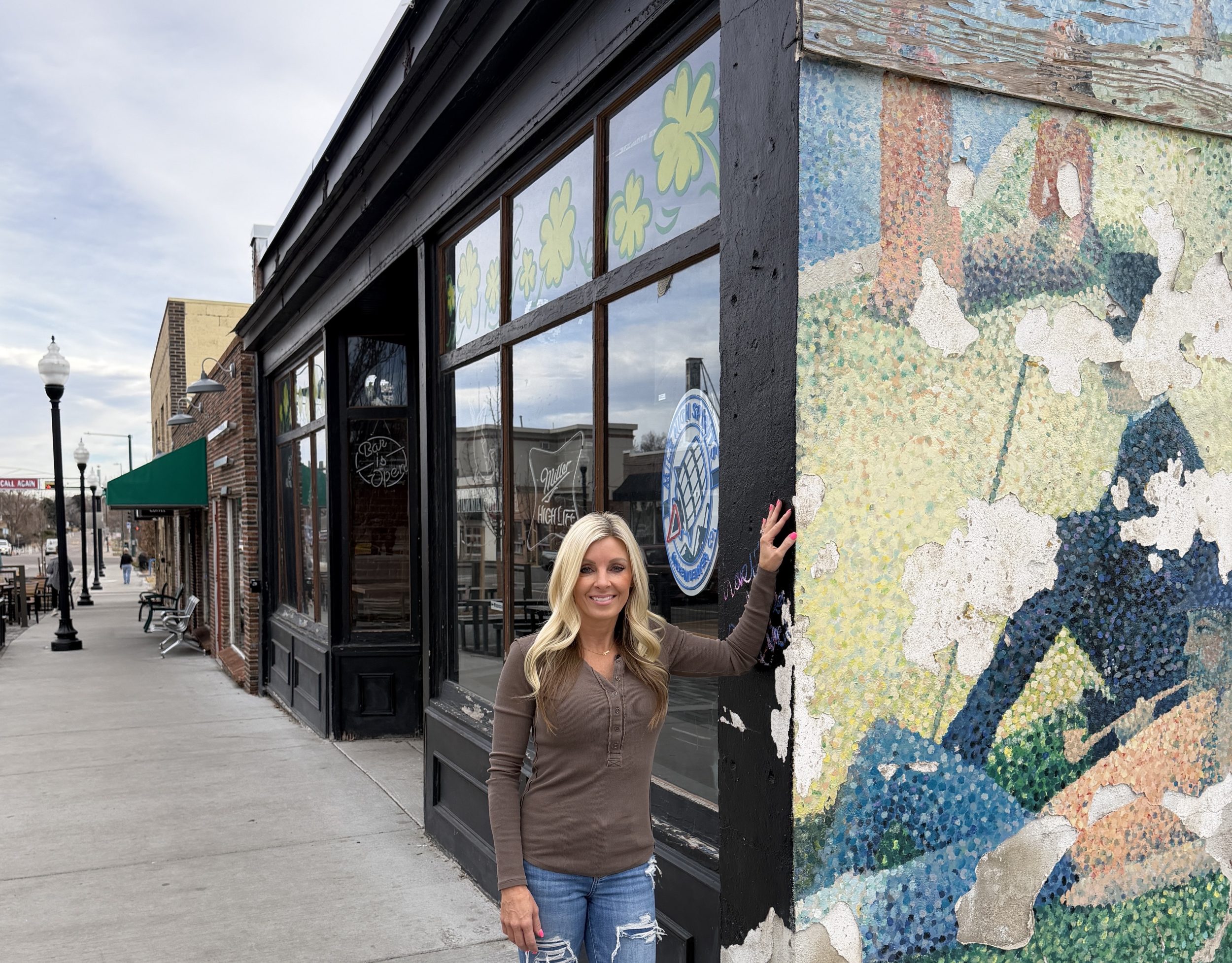a women in front of a bar.