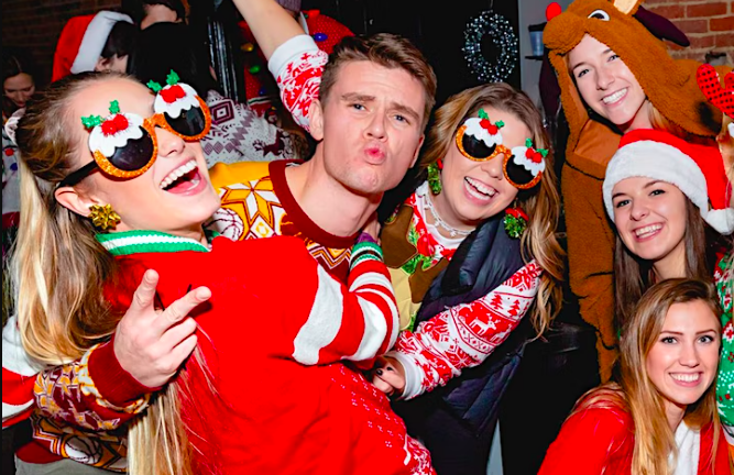 people in holiday outfits for a bar crawl