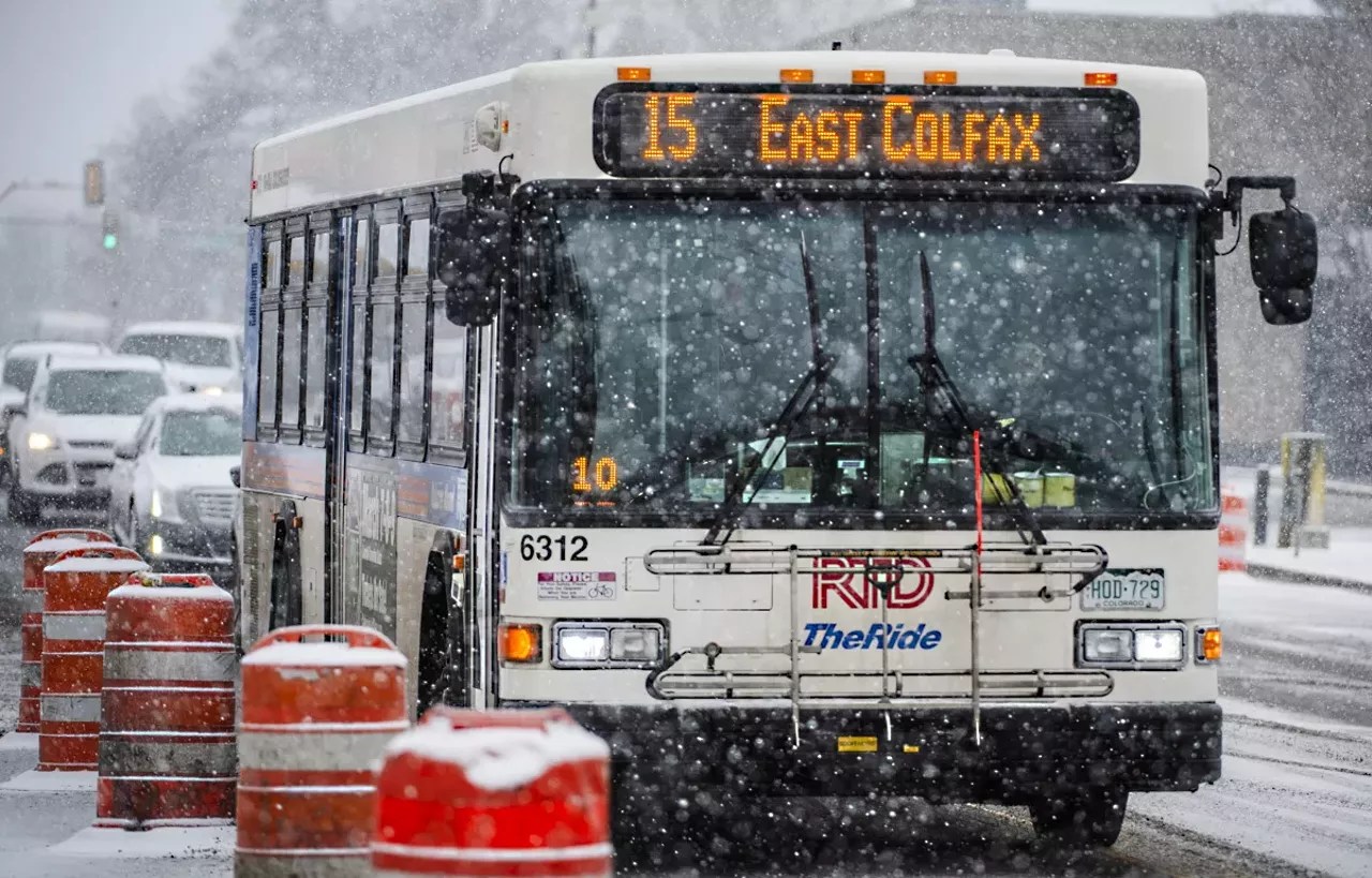 snow falls on rtd bus on colfax in denver