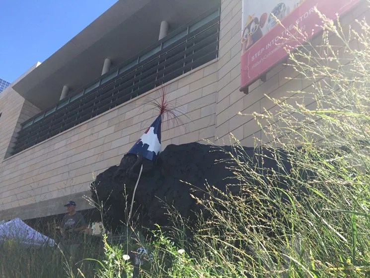 building with bison sculpture