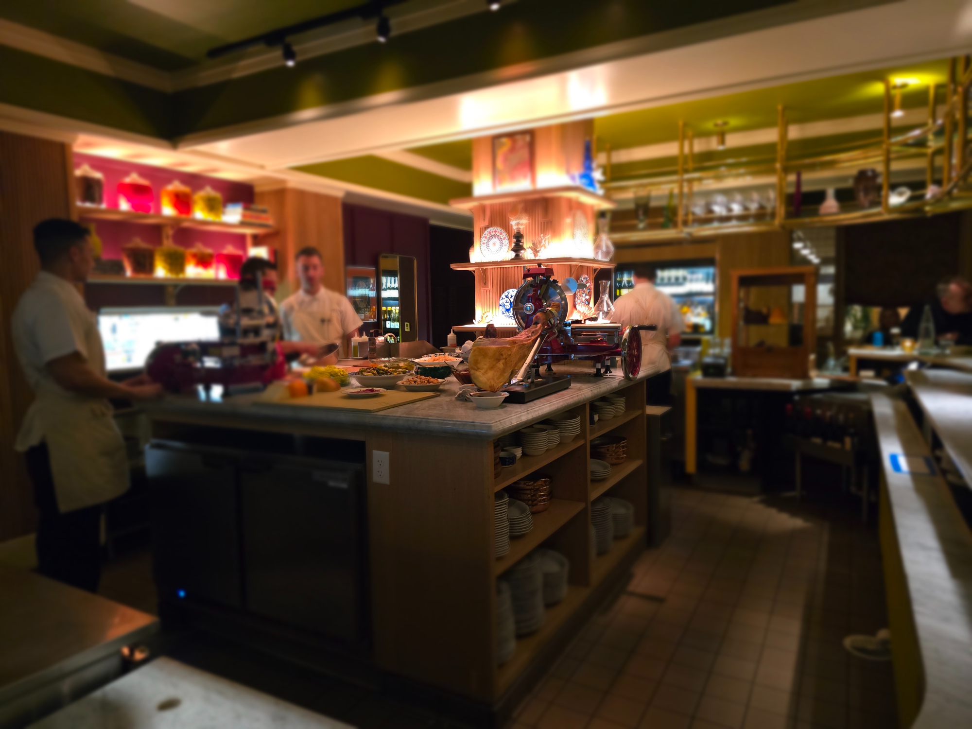 iberico ham on a large counter with slicers in a restaurant