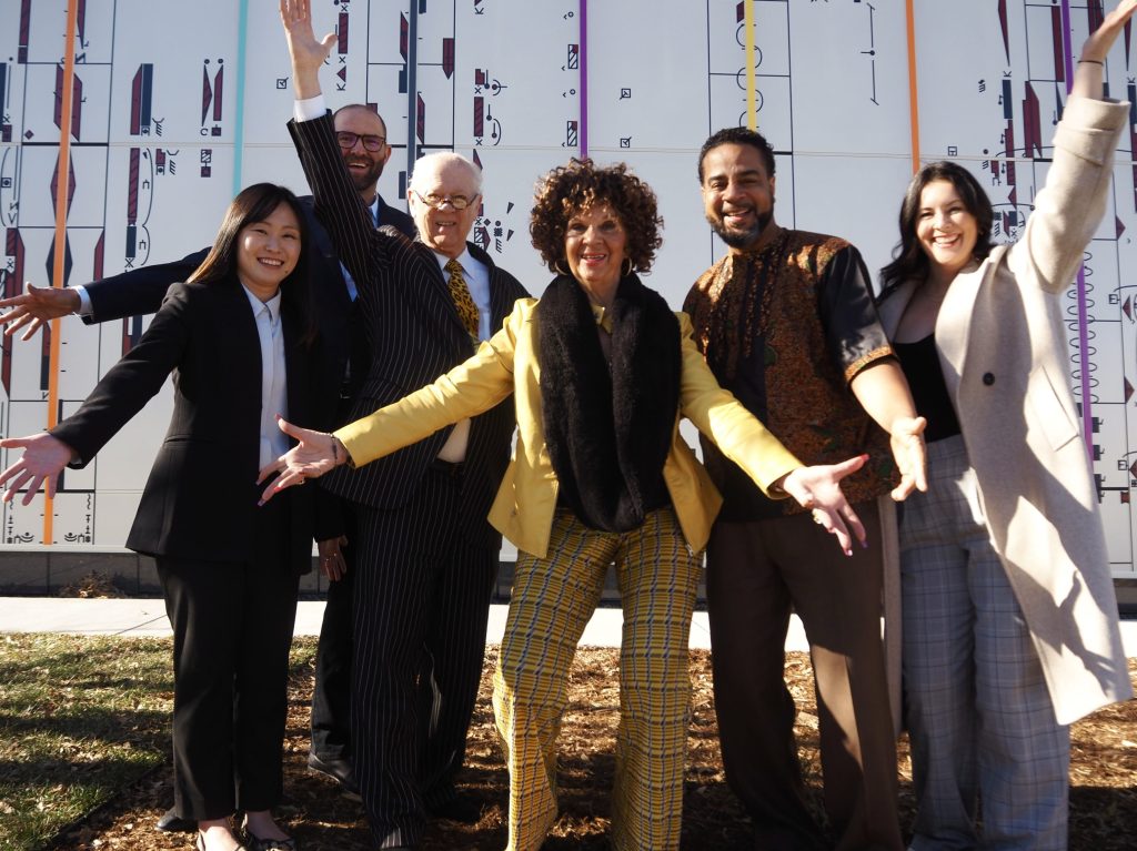 people stand in front of a building