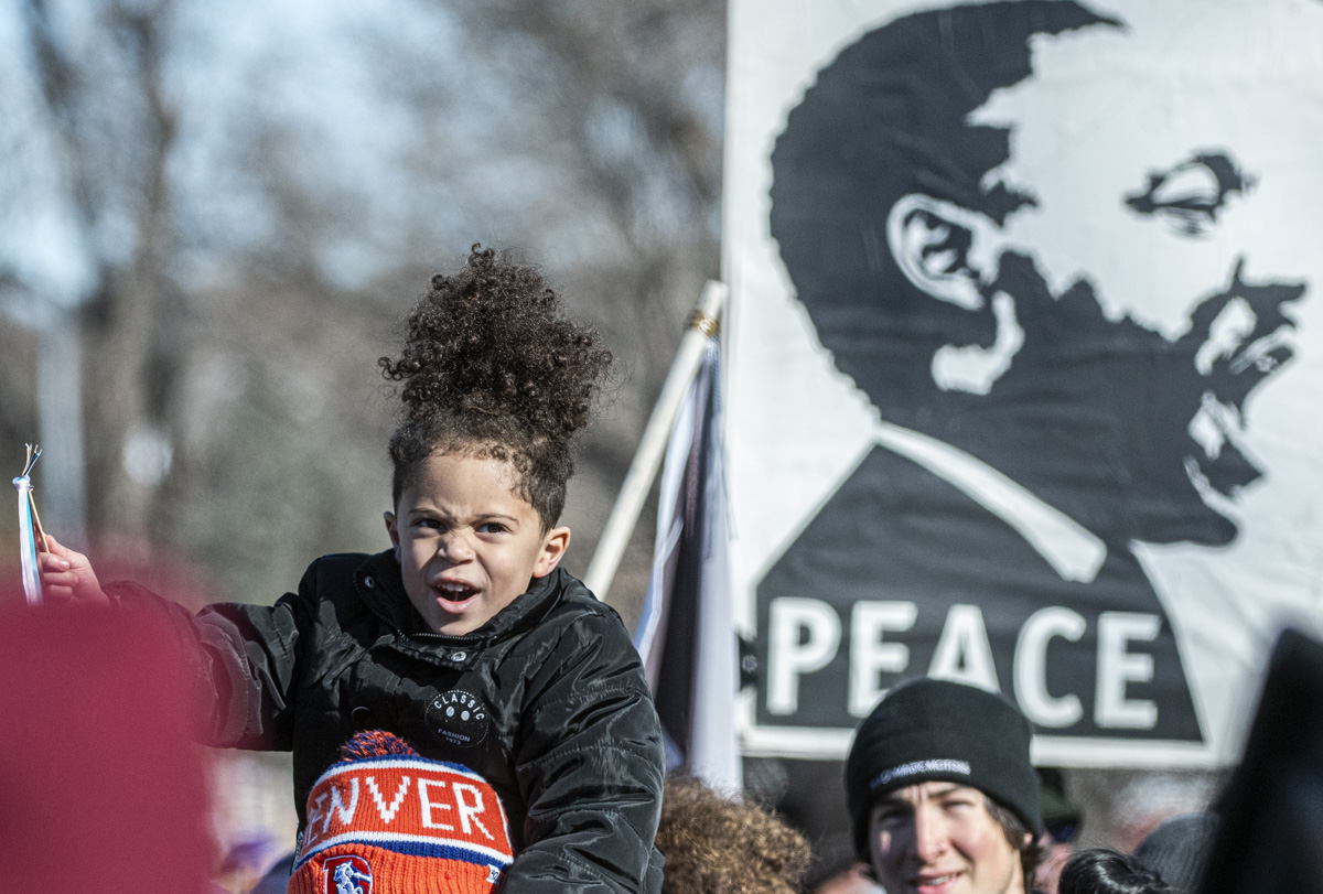 little girl on shoulders during parade