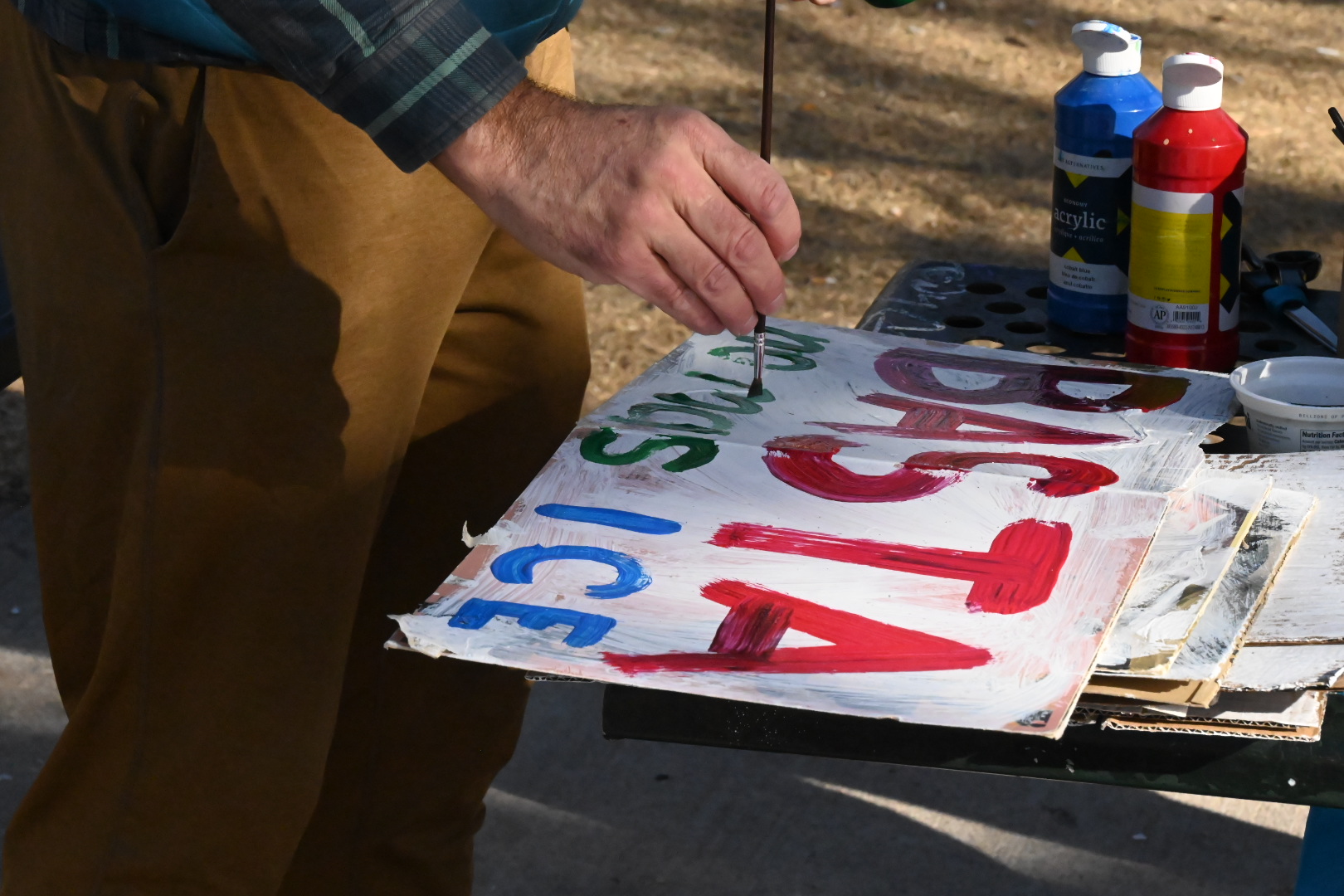 people paint protest signs