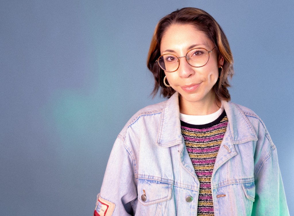 A comedian poses in a studio