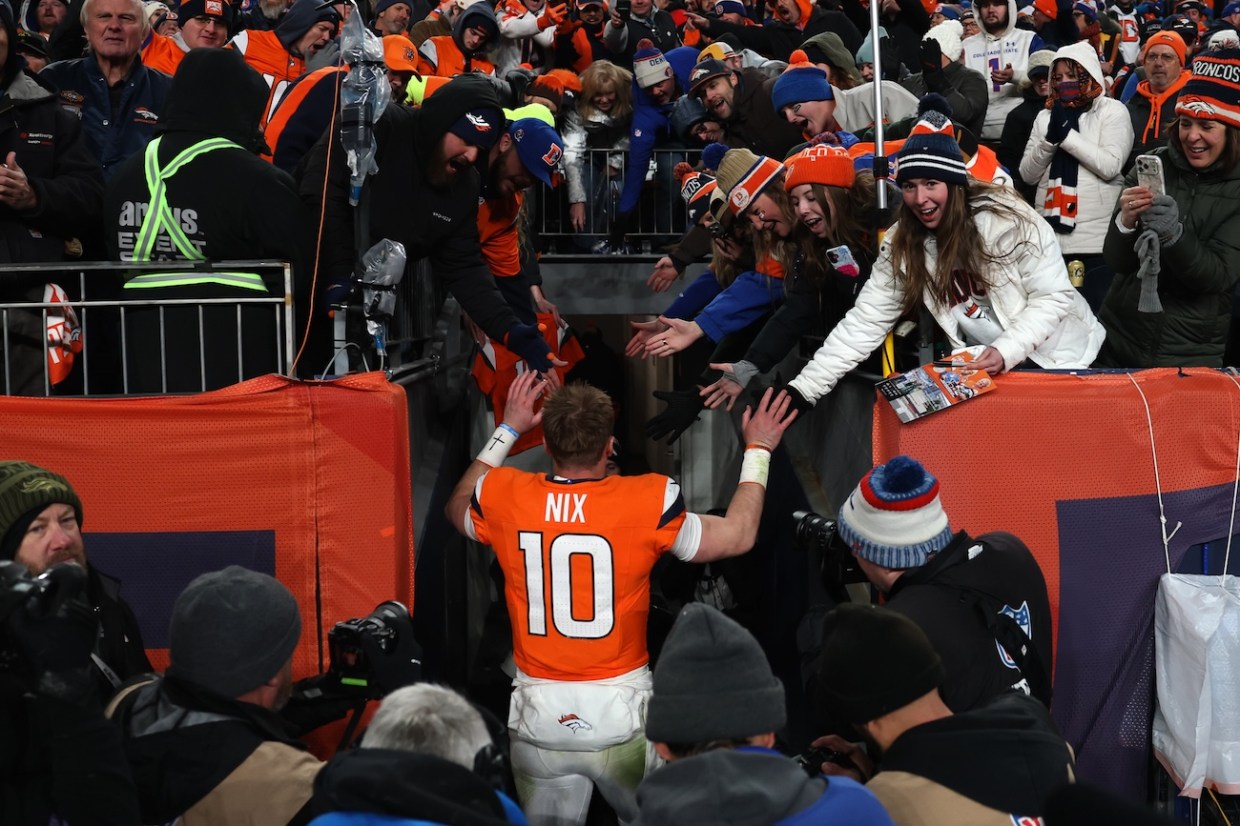 bo nix celebrates with fans after broncos game