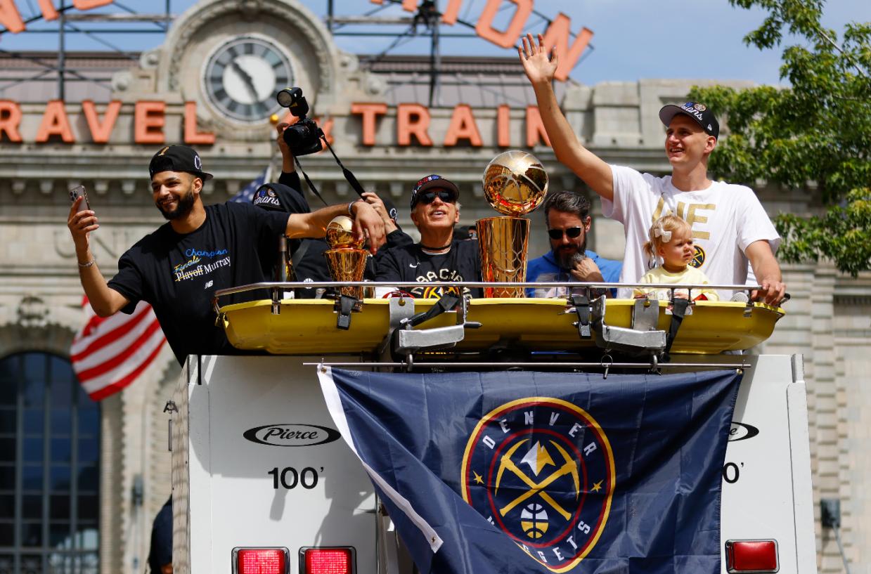 Denver Nuggets players and owner celebrate during championship parade