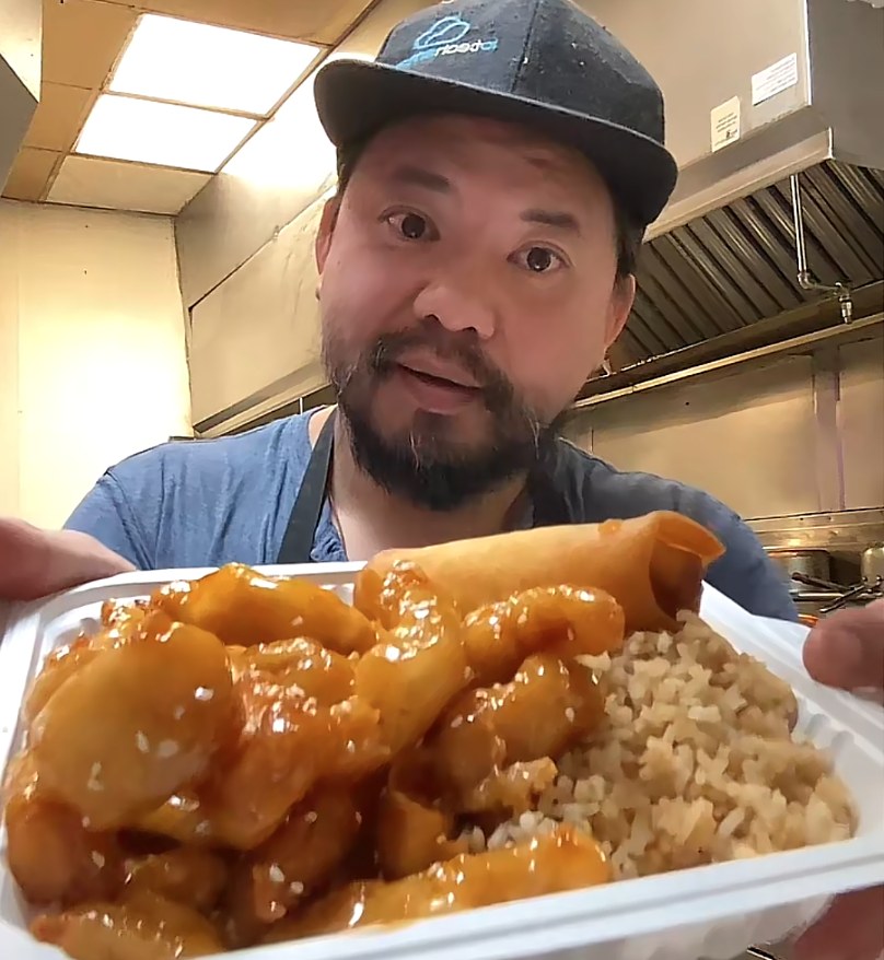 a man showing off a plate of food