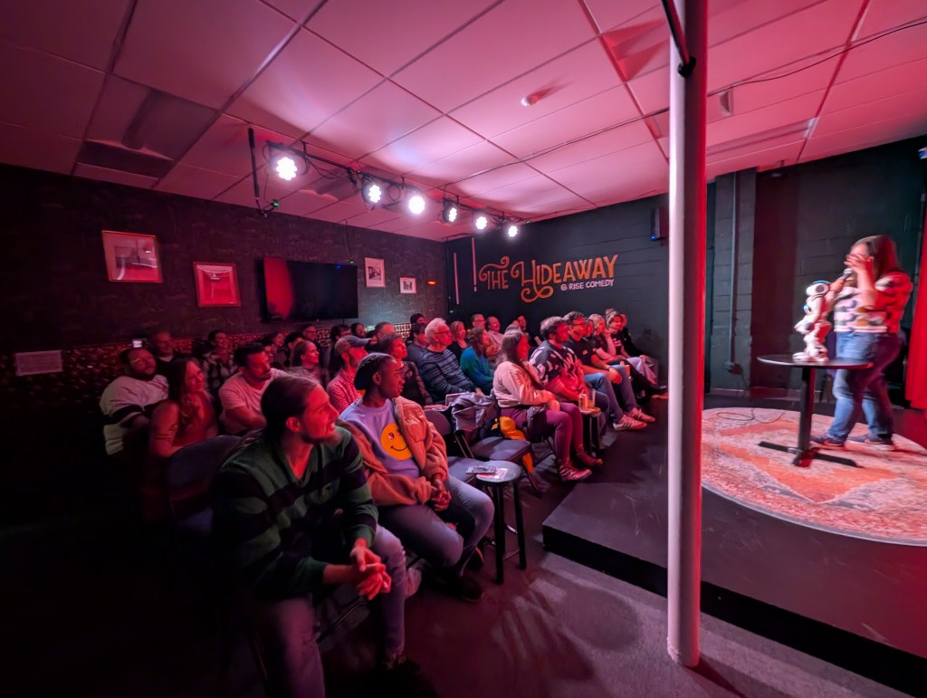 A woman performs onstage with a robot