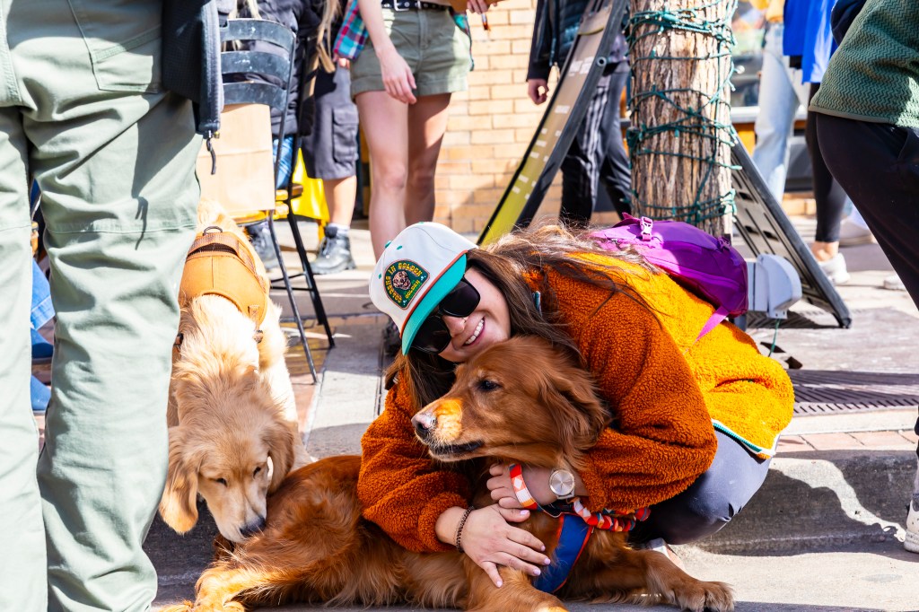 A woman hugs her dog at the annual Golden's in Golden event.