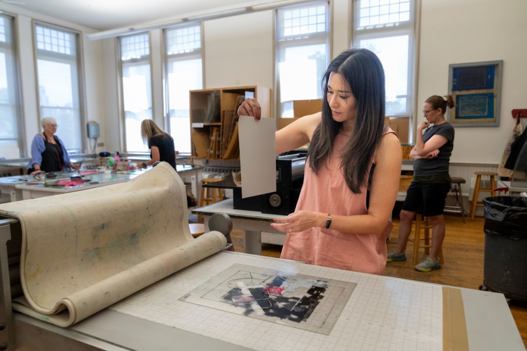 A woman holds a print