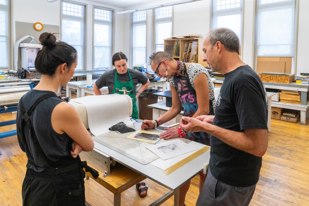 People work on a print