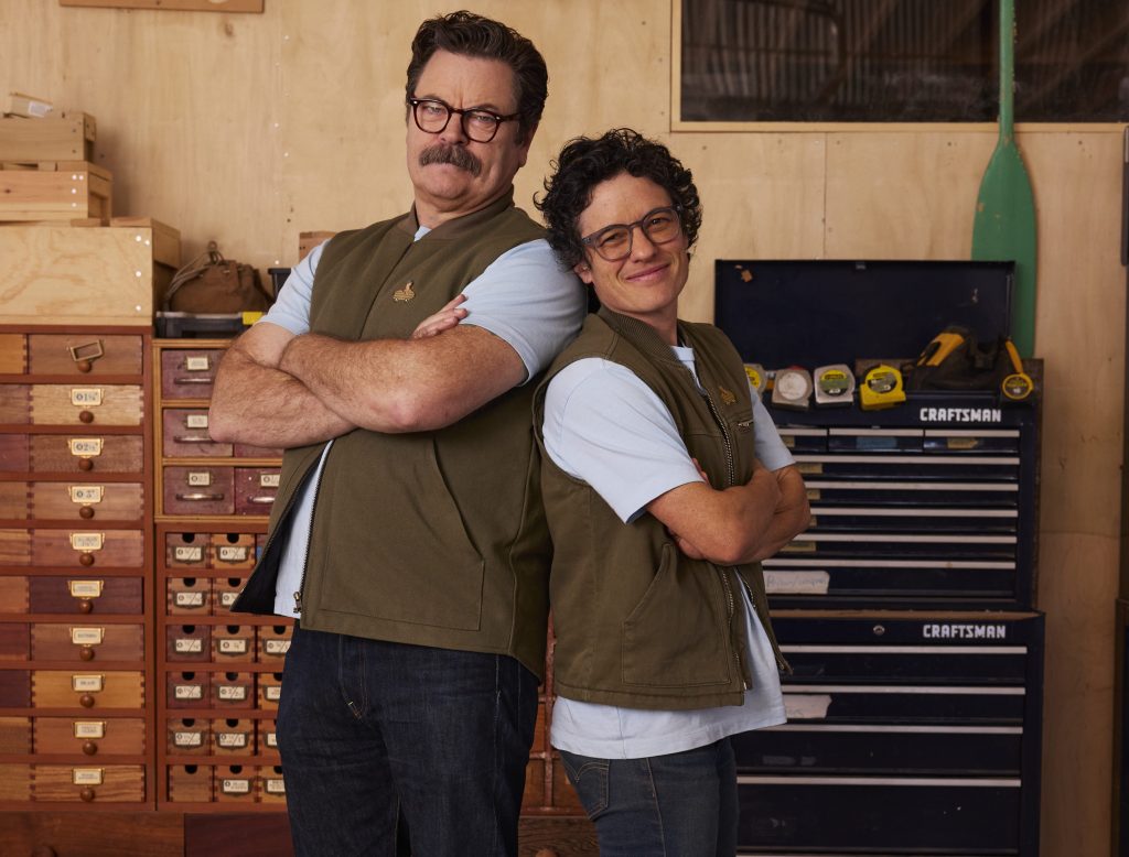 Two people stand back-to-back