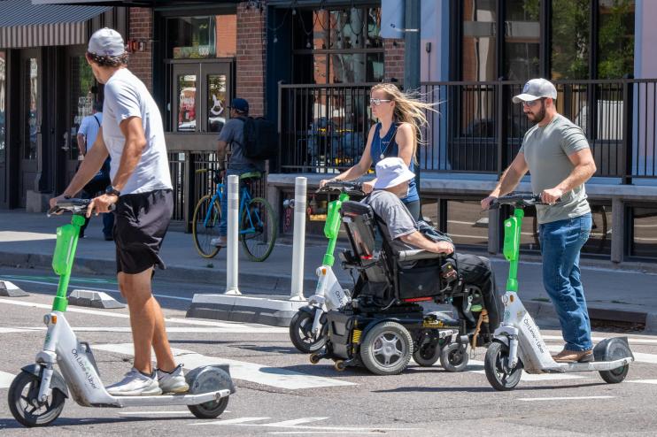 people ride e-scooters in denver