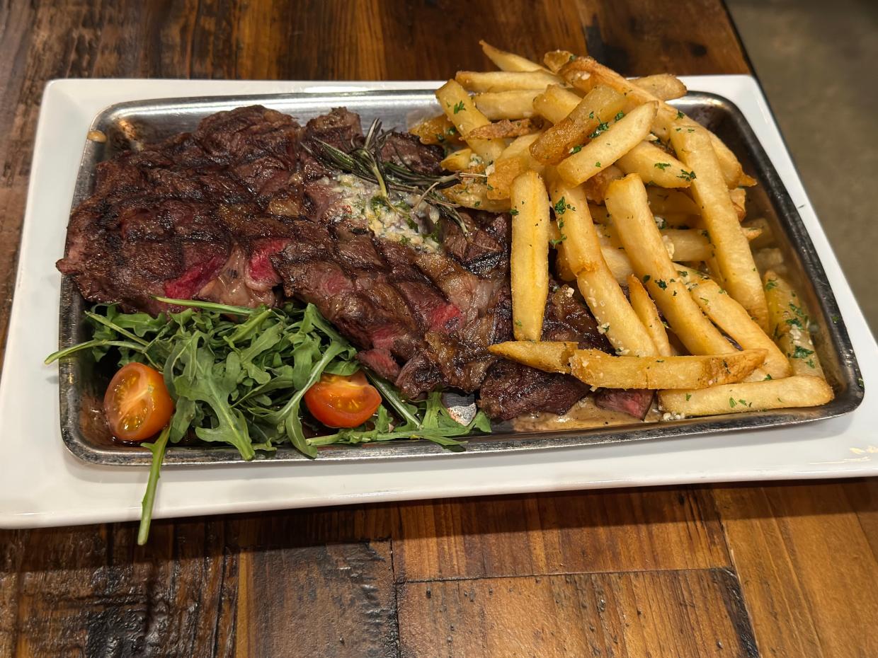 a plate of steak and french fries