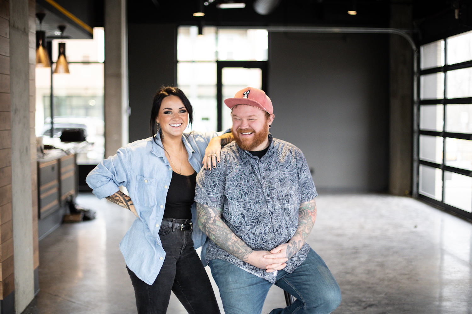 man and woman posing inside an empty room