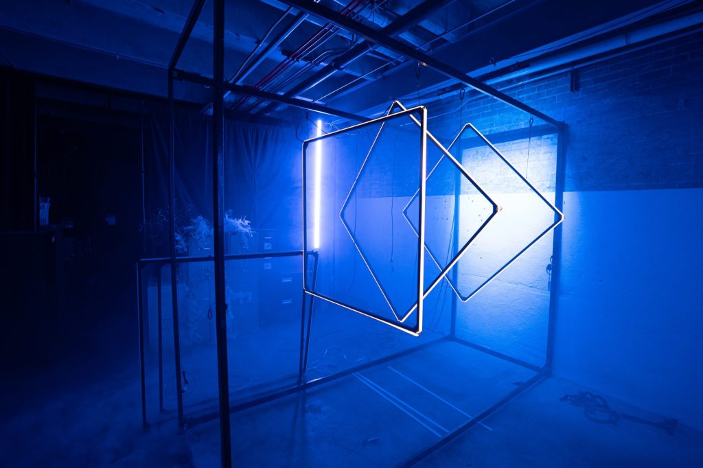 Blue lights illuminate strange items in the room