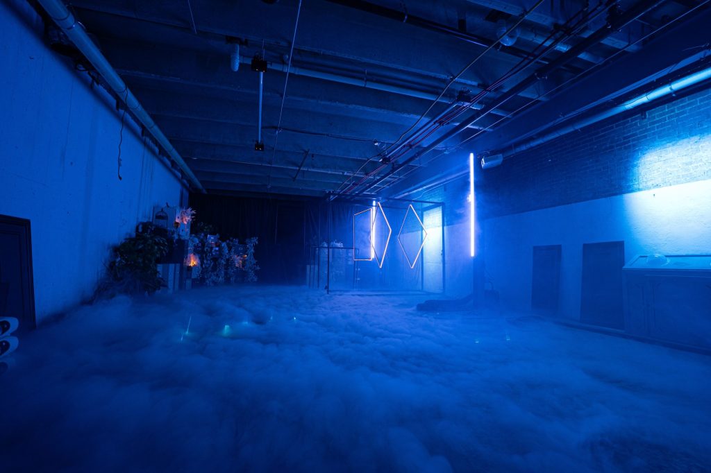 Blue lights illuminate strange items in the room