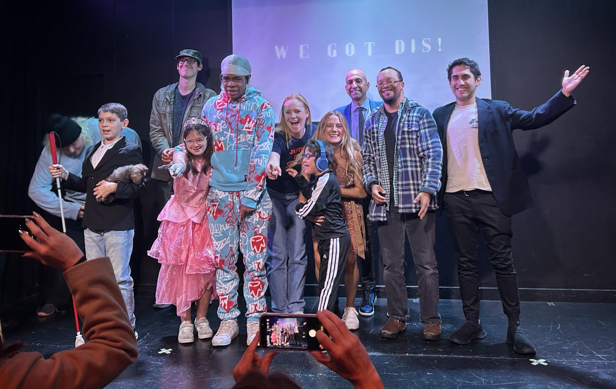 A cast pose onstage