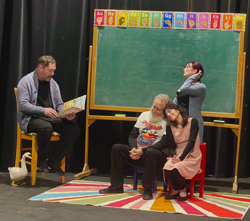 Four actors in a classroom