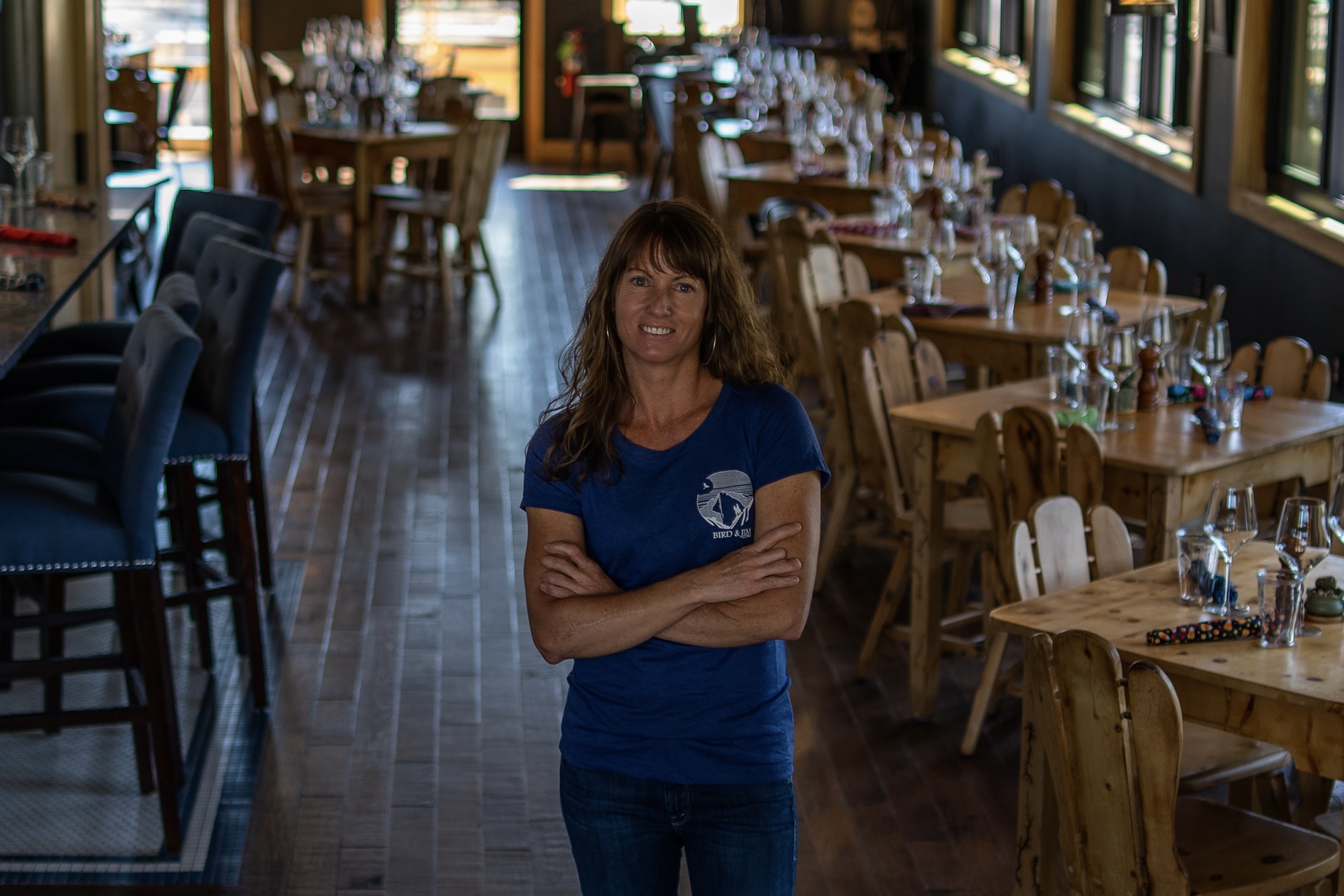 Strong in a blue Bird & Jim t-shirt, posed inside the restaurant dining room