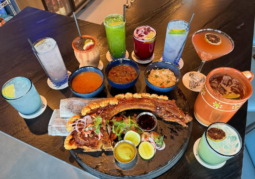 various drinks, salsas and crispy pork belly