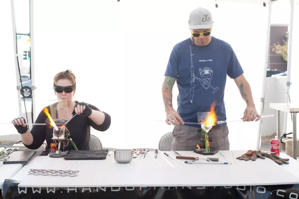 glassblowers work on pipes in public