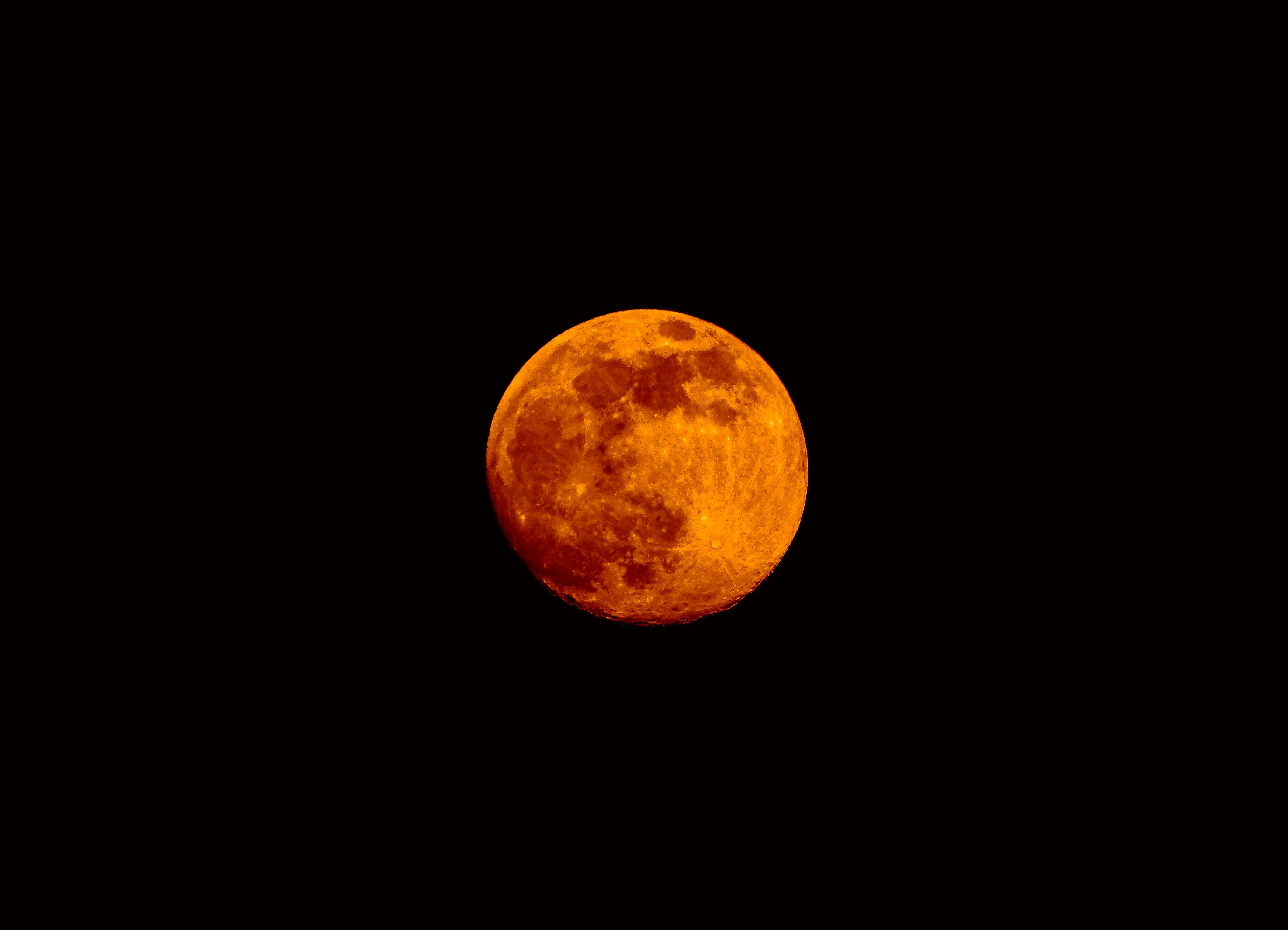 A reddish full moon