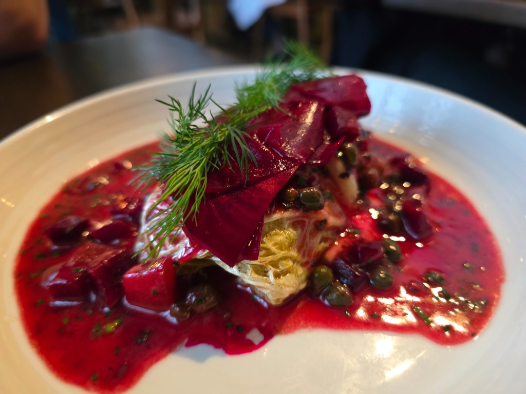 stuffed cabbage dish with beet sauce