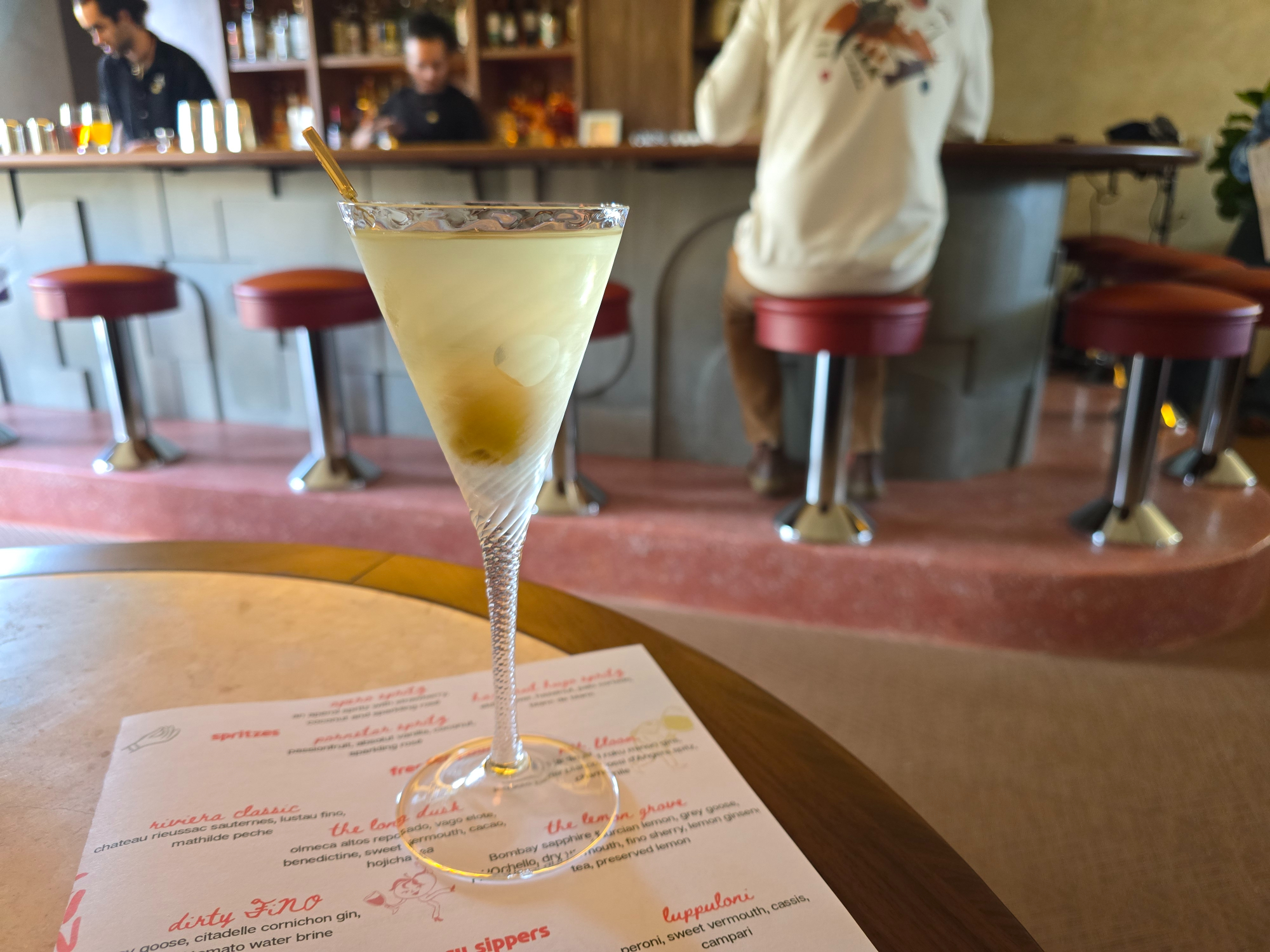 martini on a table in front of a bar