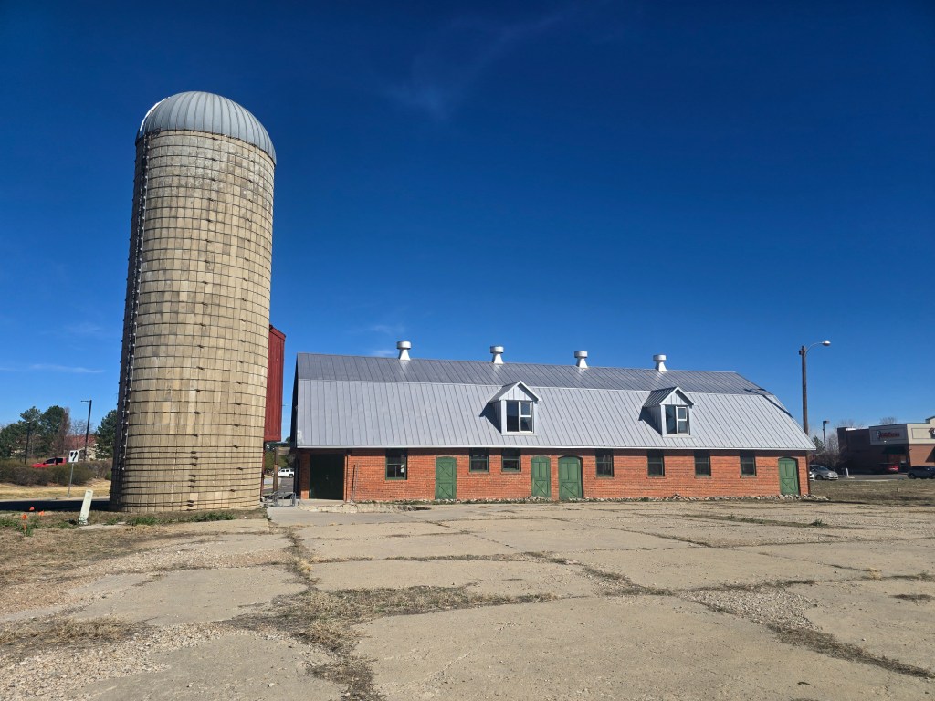 exterior of a farmhouse-style building with silo