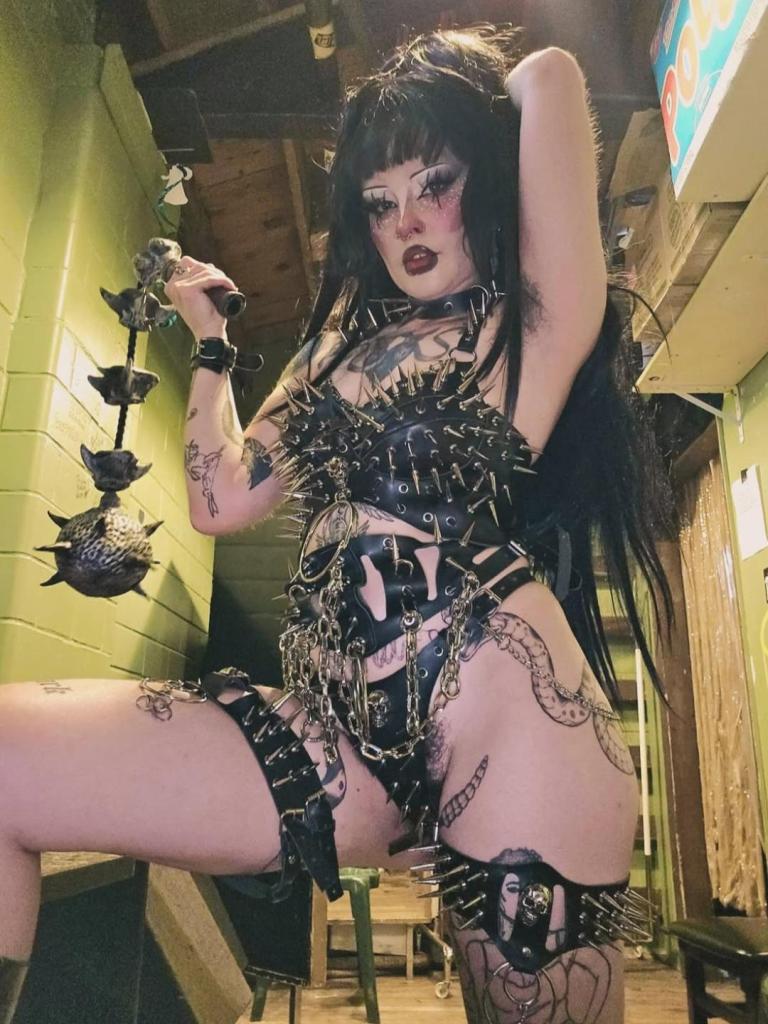 drag queen in black leather fetish gear