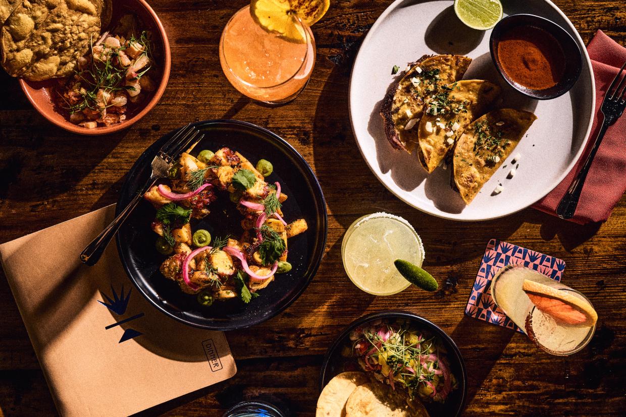 variety of Mexican dishes and cocktails on a table