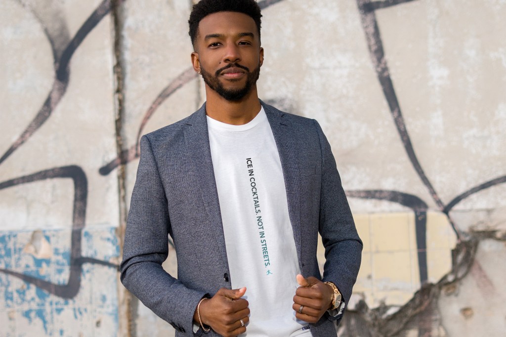Man wears a shirt that says "ice in cocktails, not in streets"